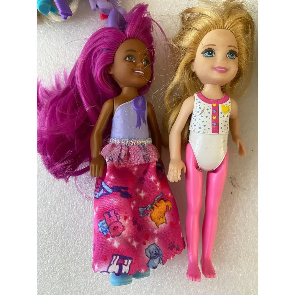 group of small Barbie Club Chelsea dolls and miniature figures in mixed outfits